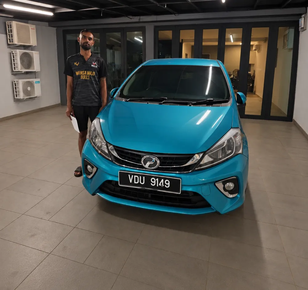 A buyer with his blue Perodua Myvi