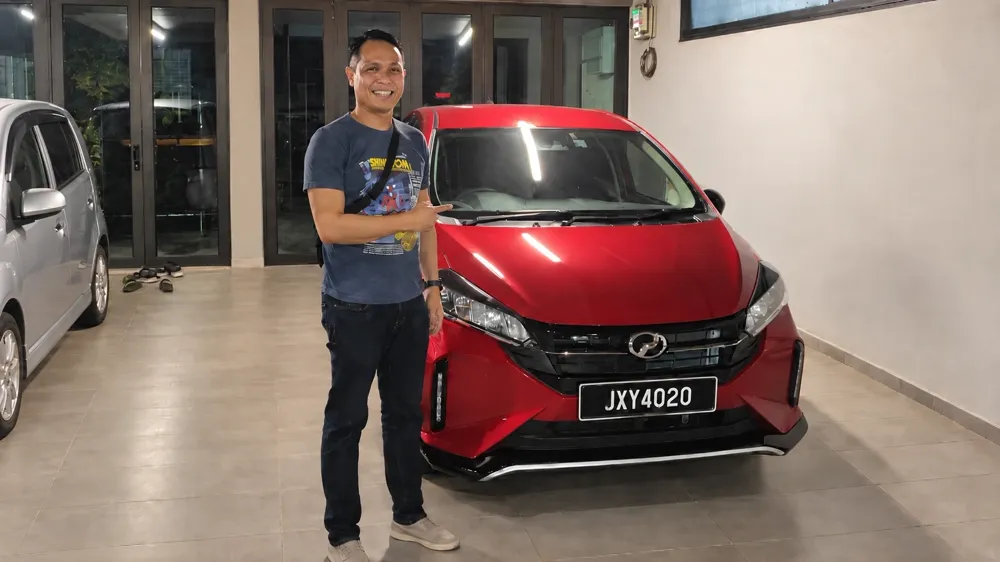 A buyer with his red Perodua Myvi